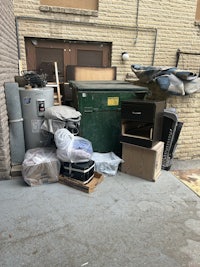 a brick building with a lot of junk in front of it