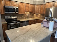 a kitchen with wooden cabinets and a microwave