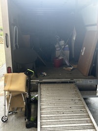 the back of a moving truck with furniture in it