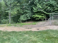 an aerial view of a dirt path in a wooded area